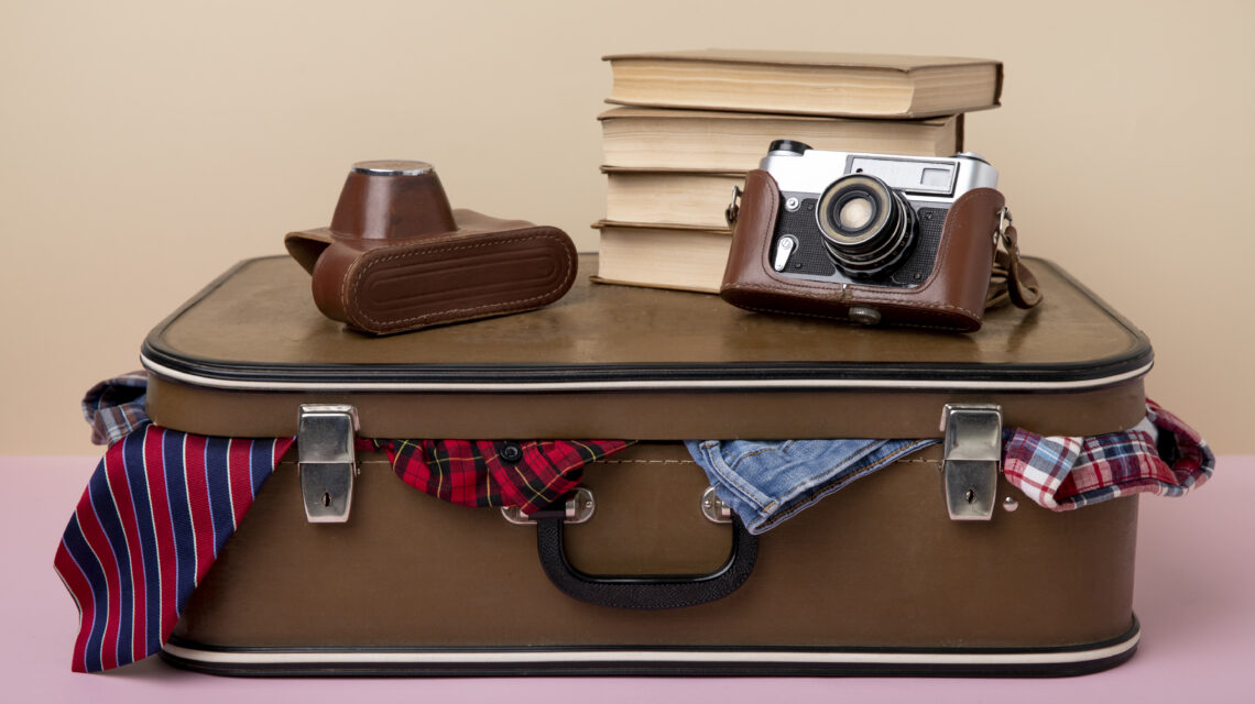 leather-suitcase-packed-with-camera-books
