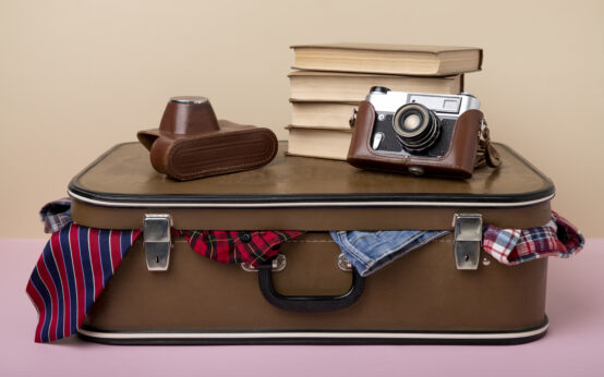 leather-suitcase-packed-with-camera-books