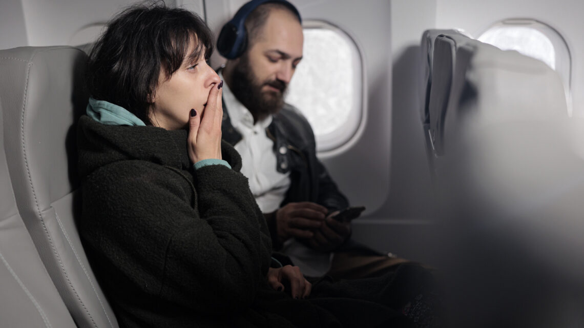 Woman feeling tense and scared about airplane takeoff