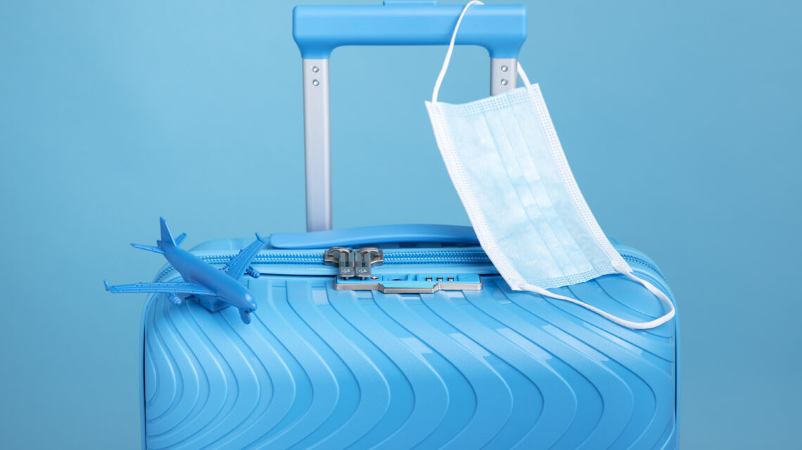 blue-suitcase-travel-with-medical-mask