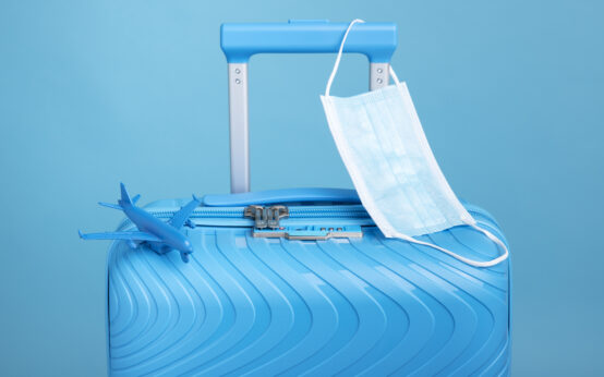 blue-suitcase-travel-with-medical-mask
